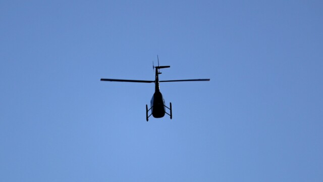 Whirlybird flying over the Coquitlam River Whirlybird flying over the Coquitlam River