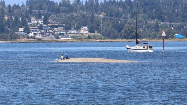 Kayakers establishing landfall on a tiny spit.